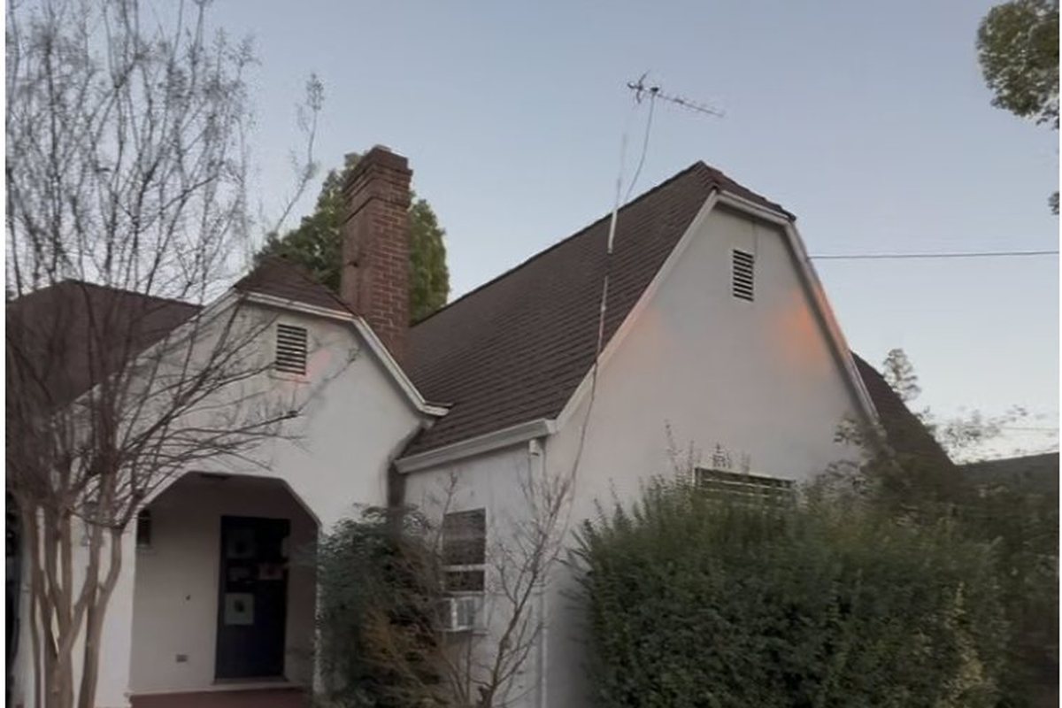 Olive Street before rehabilitation: overgrown shrubs, stained roof, dated exterior
